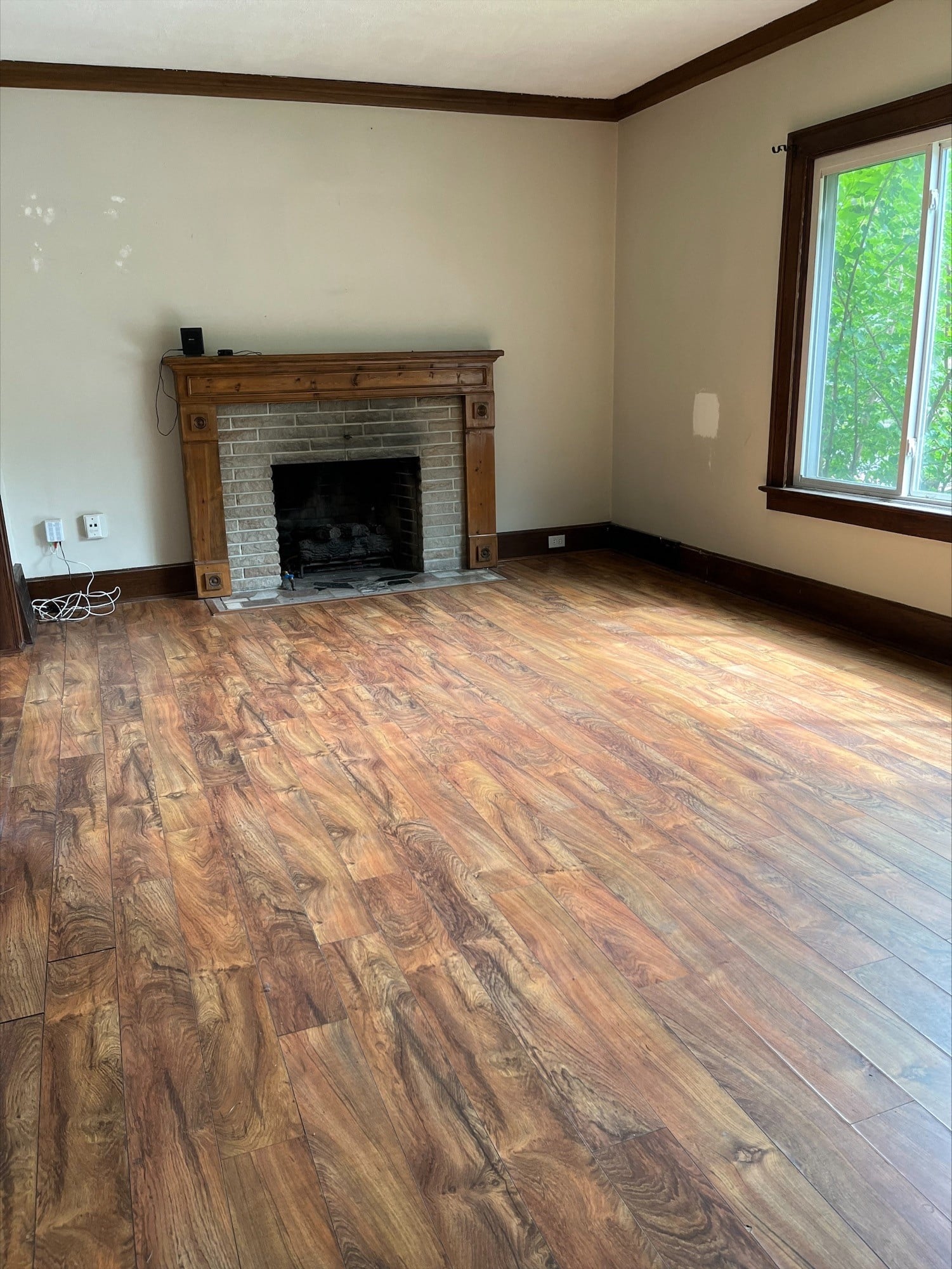 a living room with a fireplace and a wooden floor