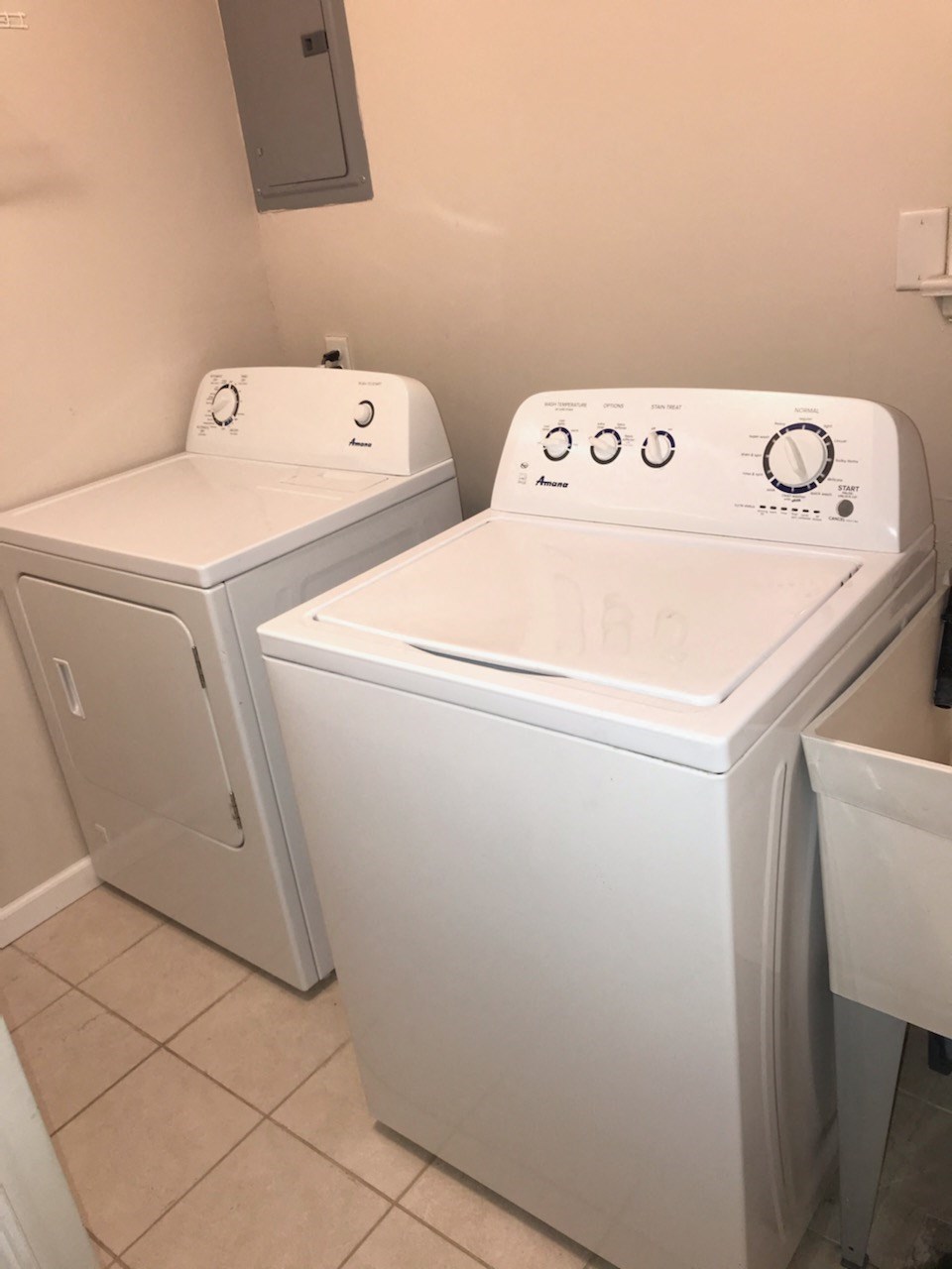 a washing machine and a washer and dryer in a room