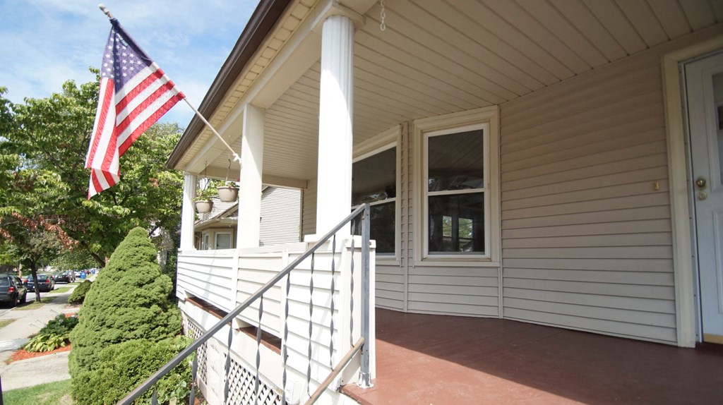 a home with an flag on the front porch