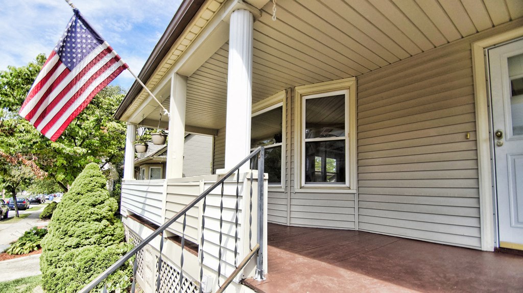a home with an flag on the front porch