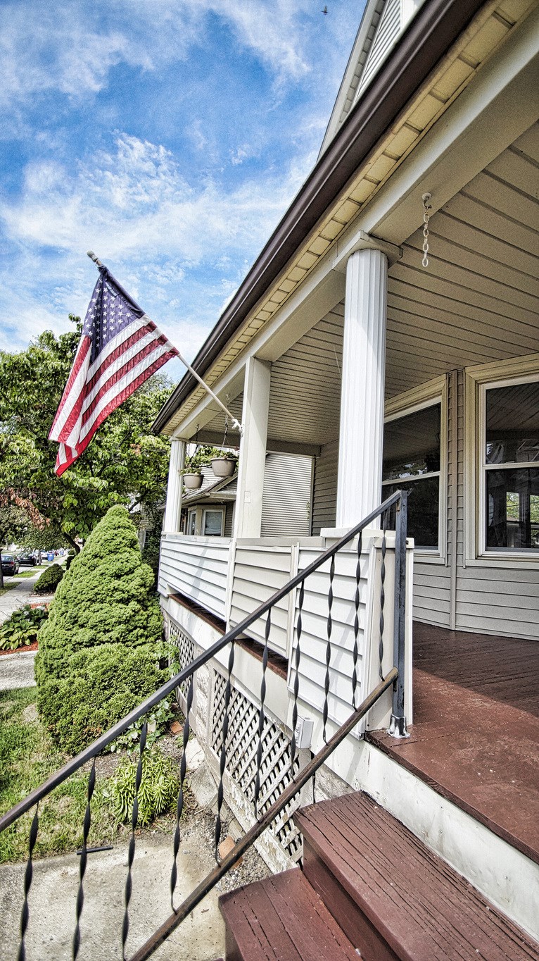 a flag is flying on the side of a house