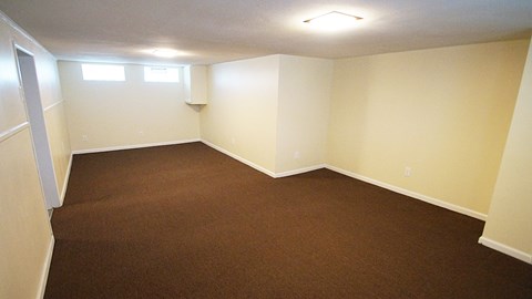 A room with brown carpet and white walls.