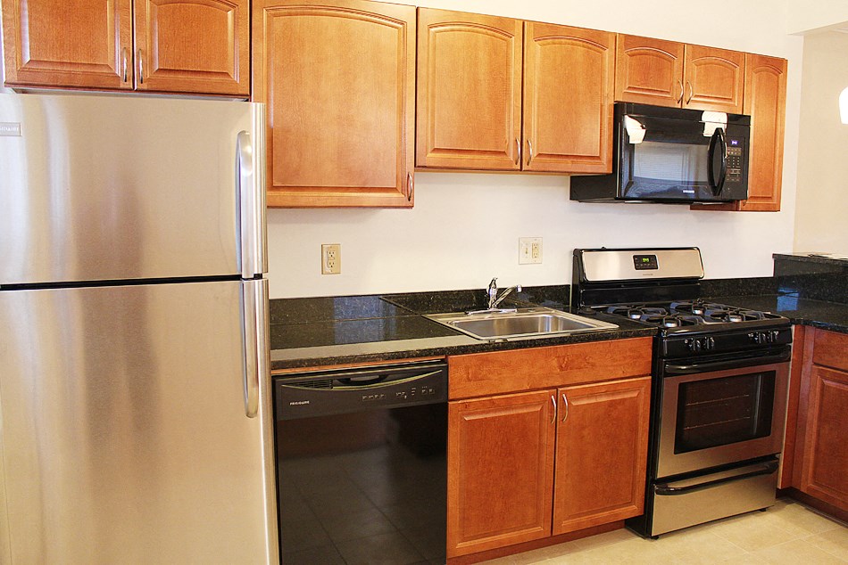 a kitchen with stainless steel appliances and wooden cabinets