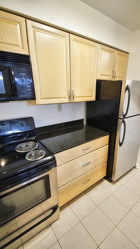 a kitchen with a stove and a refrigerator