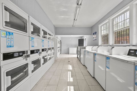 a kitchen with rows of microwaves and sinks