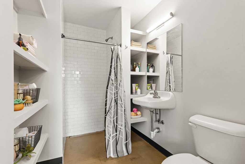 A white bathroom with a white tub and a white sink.