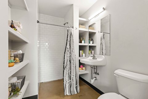 A white bathroom with a white tub and a white sink.