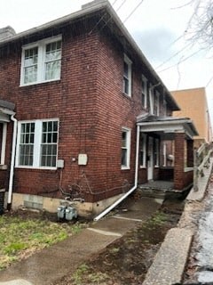 the front of a brick house with a porch