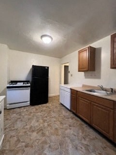 a kitchen with a stove and a sink and a refrigerator