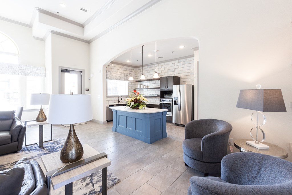 a living room with a kitchen with a blue island