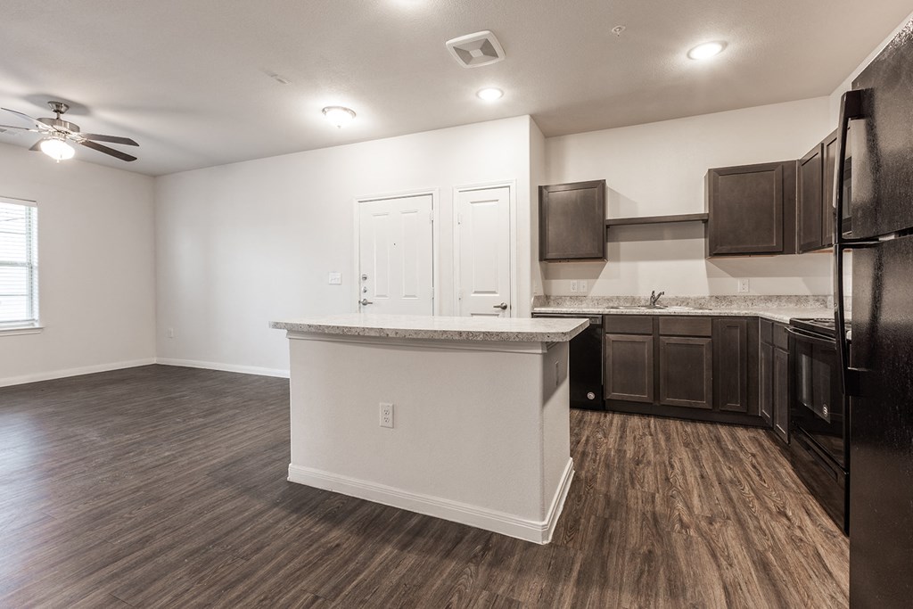 an empty kitchen with a counter top in the middle