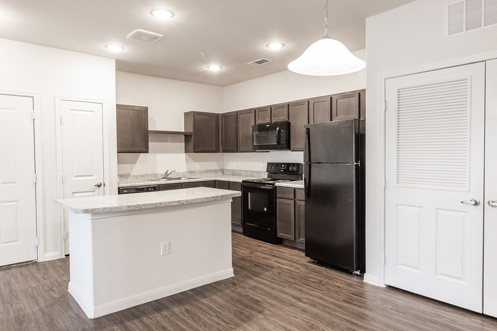 a kitchen with stainless steel appliances and a white counter top