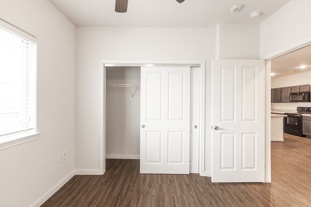 a renovated living room with white doors and a closet
