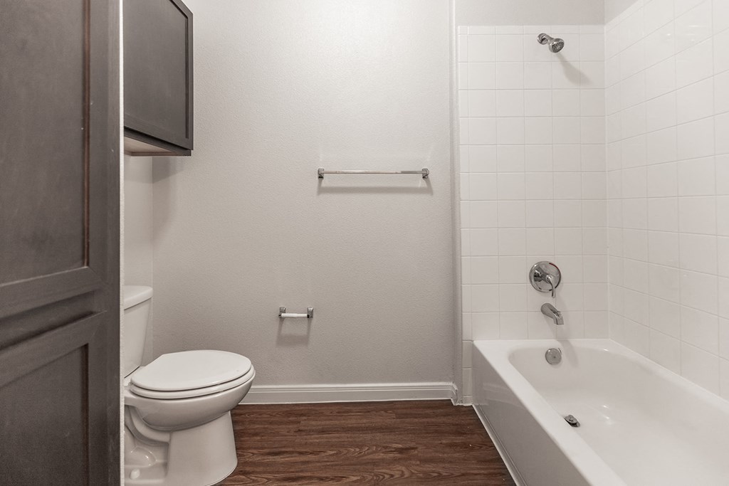 a bathroom with a toilet and a tub and a sink