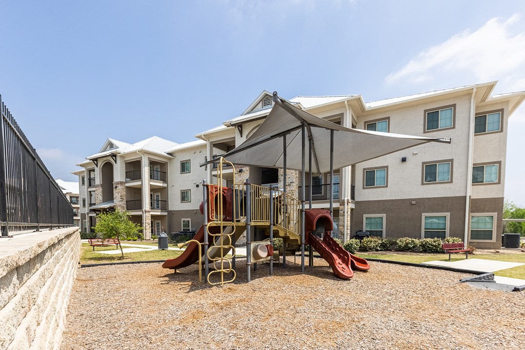 the preserve at ballantyne commons playground with play structures and apartment buildings