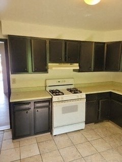 a kitchen with a white stove and black cabinets