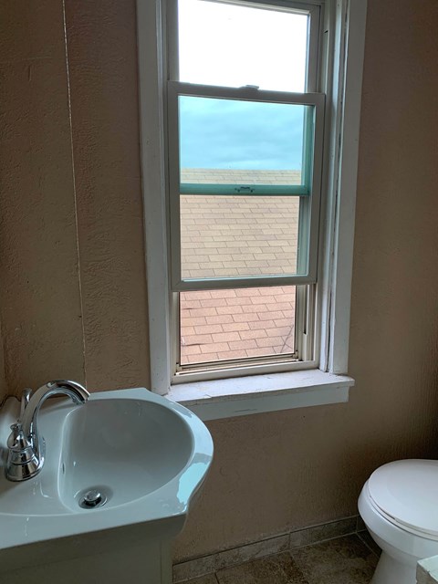 a bathroom with a sink and a window