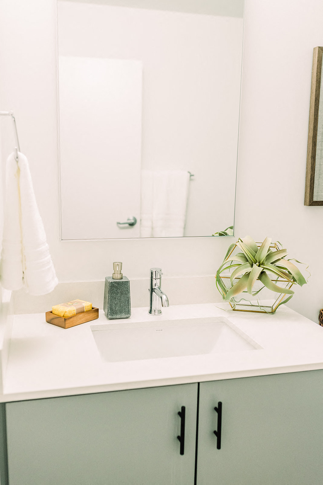 a white bathroom with a sink and a mirror