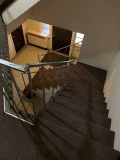 a staircase with a dog laying down on the floor