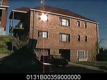 a car is parked in front of a brick building