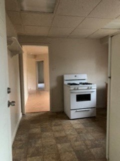an empty kitchen with a white stove in it
