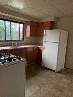 a kitchen with a white refrigerator and a stove