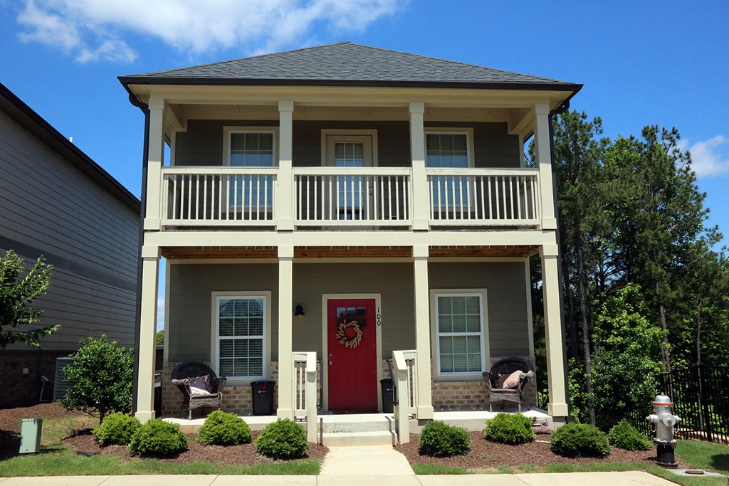 the front of a house with a red door