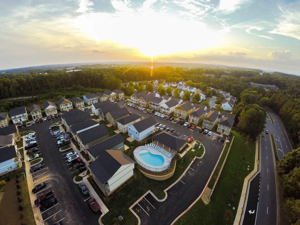 an aerial view of a community with houses and a pool