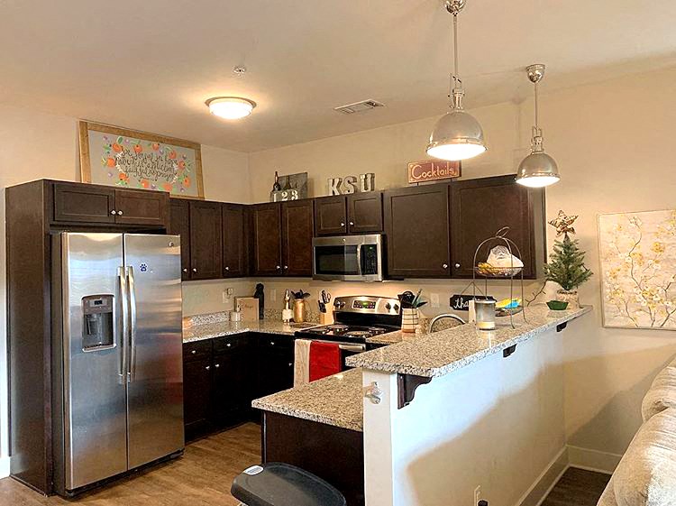 a kitchen with stainless steel appliances and a counter top
