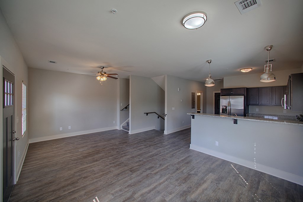 an empty living room and kitchen in a new home