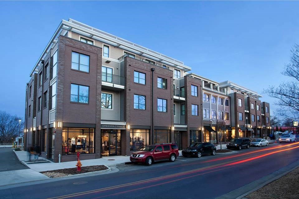 a building with cars parked in front of it on a street