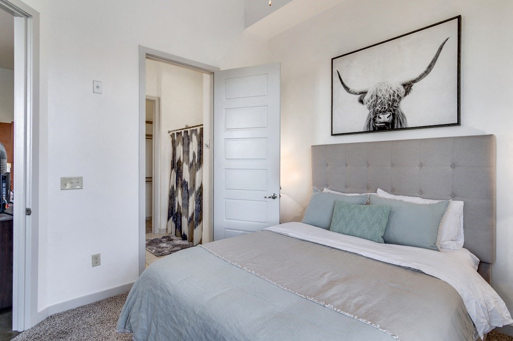 a bedroom with a bed and a picture of a bull