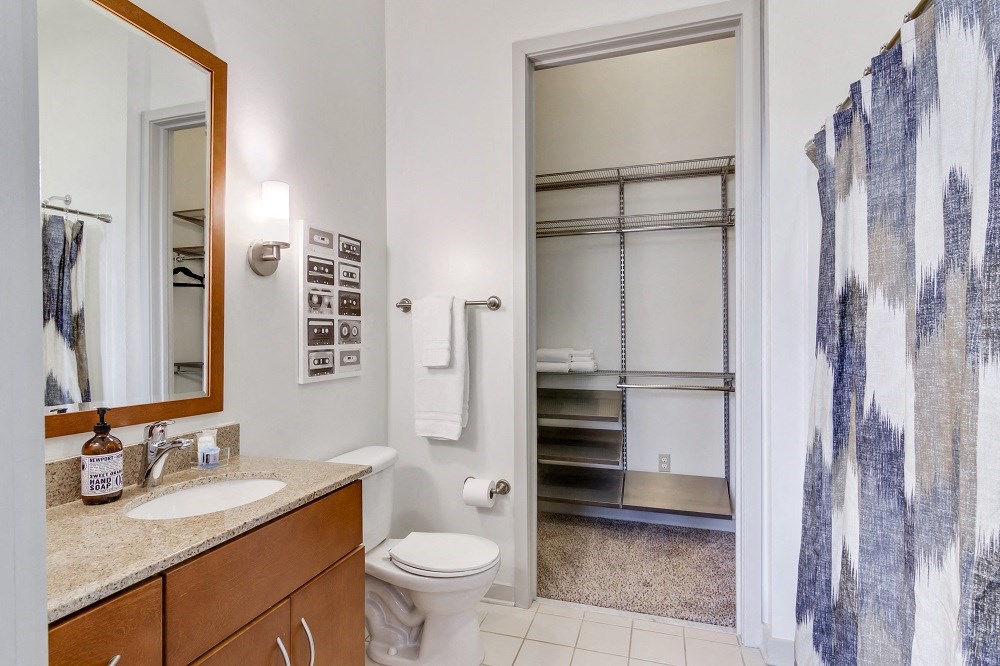 a bathroom with a shower toilet and sink and a mirror