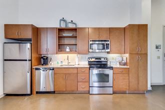 a kitchen with wooden cabinets and stainless steel appliances