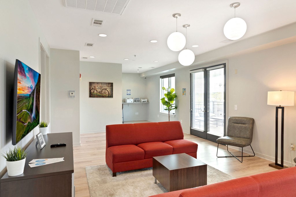 a living room with a red couch and a table