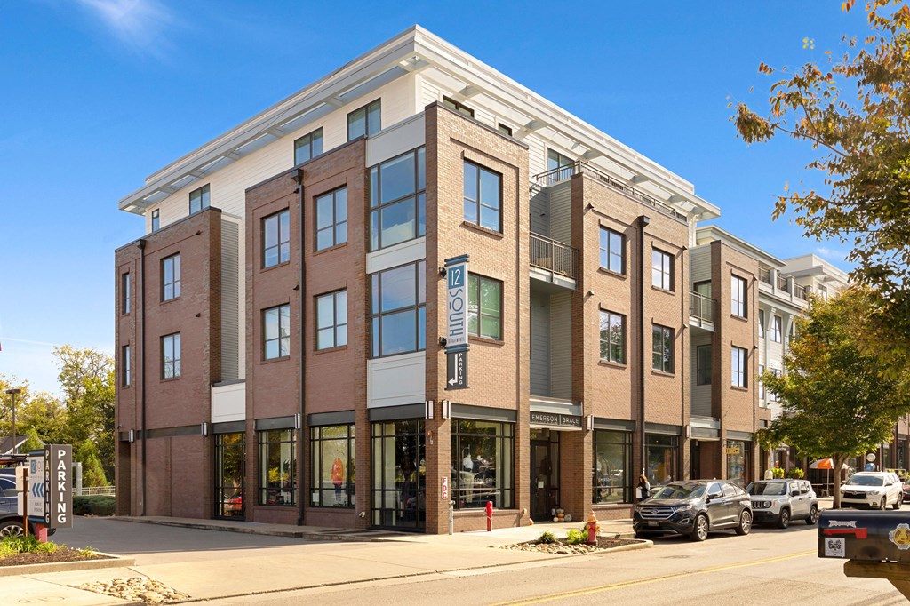 a brick building on a city street with cars