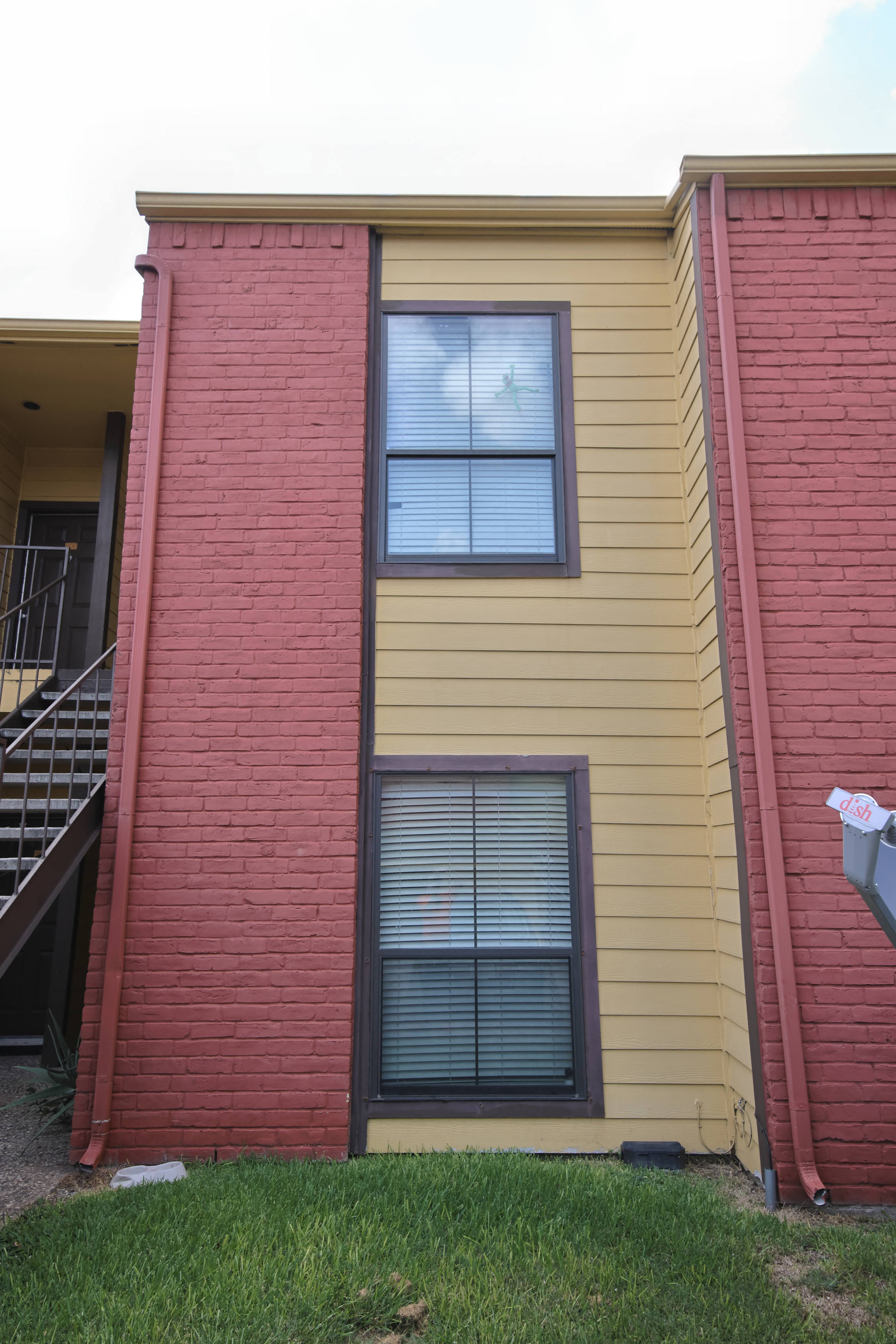 the outside of a brick building with two windows