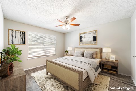 a bedroom with a bed and a ceiling fan
