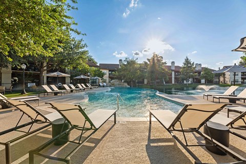 A sunny day at the pool with lounge chairs and umbrellas.