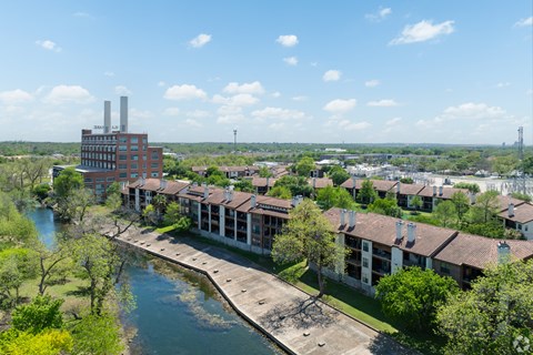 A river flows through a city with a bridge over it.