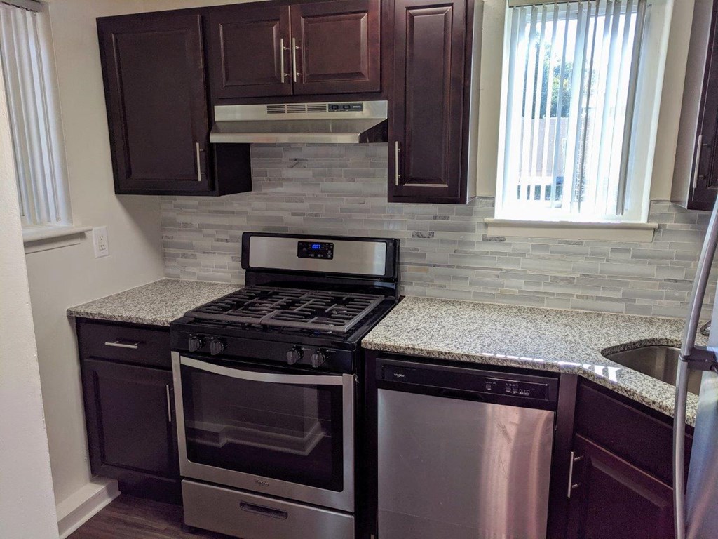 a kitchen with stainless steel appliances and a counter top