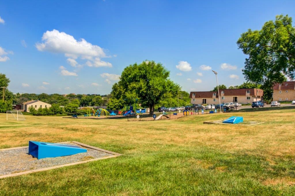 a park with several trampolines in the grass