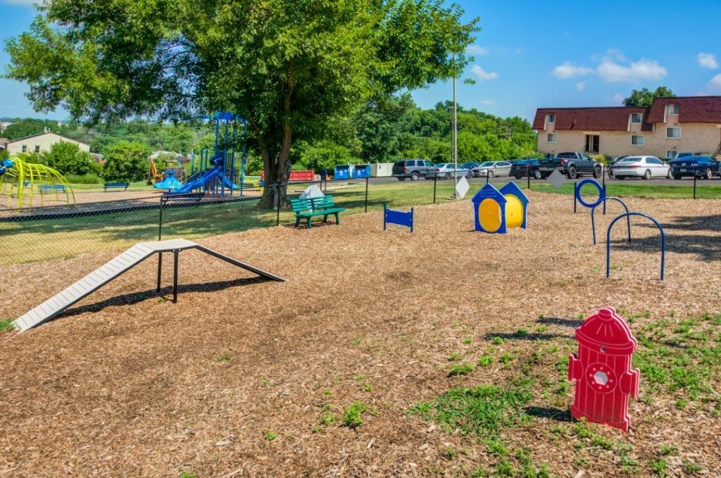 a park with a playground and a fire hydrant