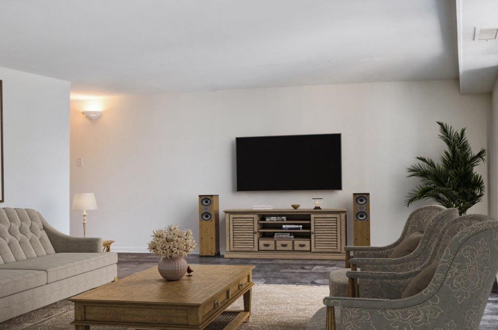 a living room with a couch and a television on the wall