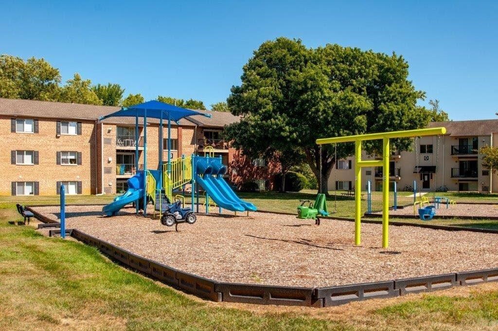 the playground is in front of an apartment building
