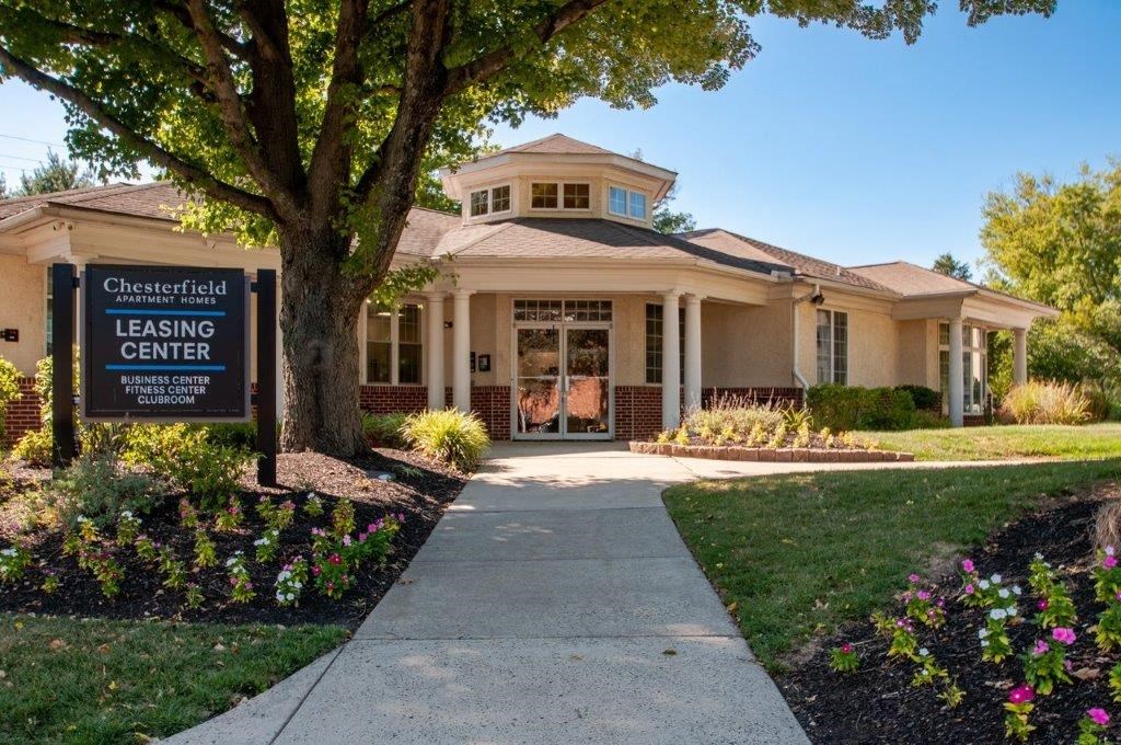 a building with a leasing center sign in front of it