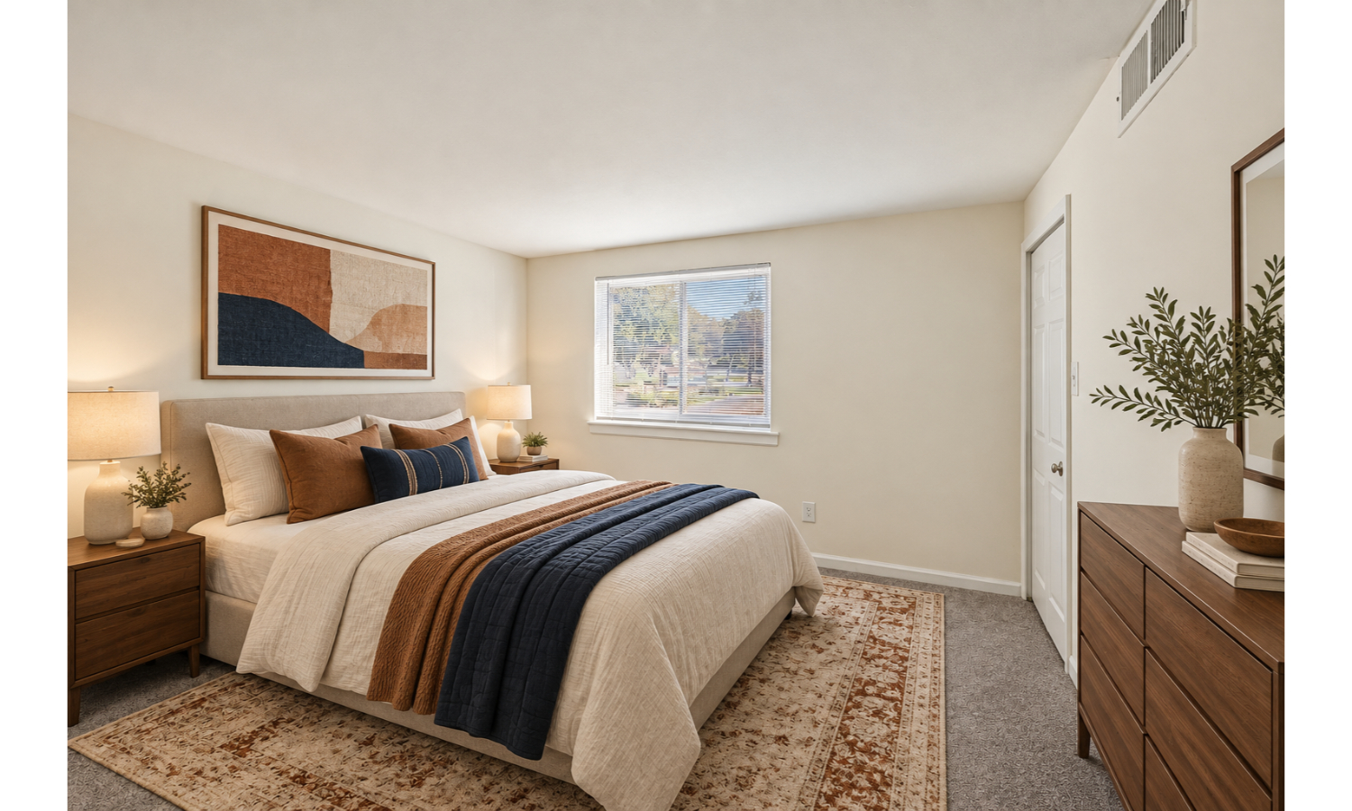 A bedroom with a bed, nightstand, and a painting on the wall.