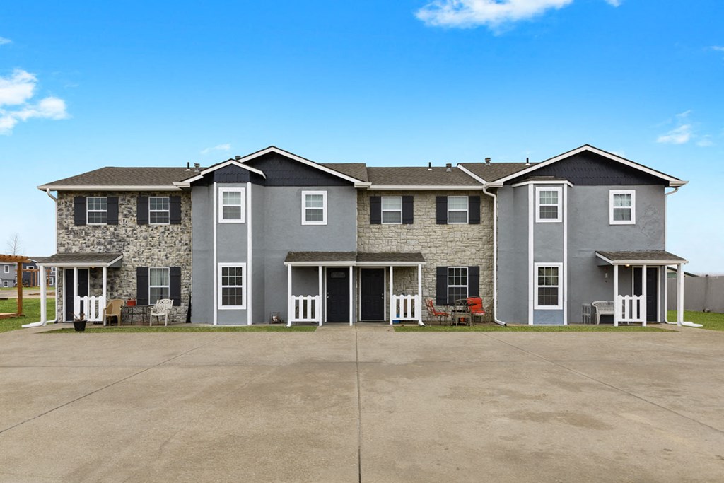 a large apartment building with a parking lot