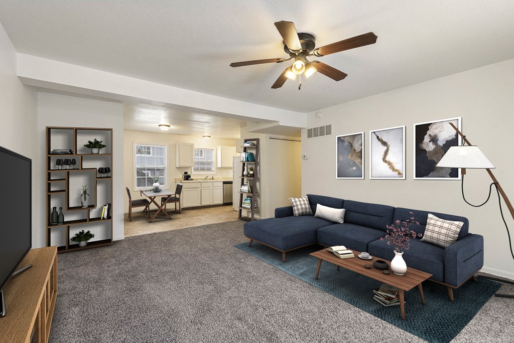 a living room with a blue couch and a ceiling fan