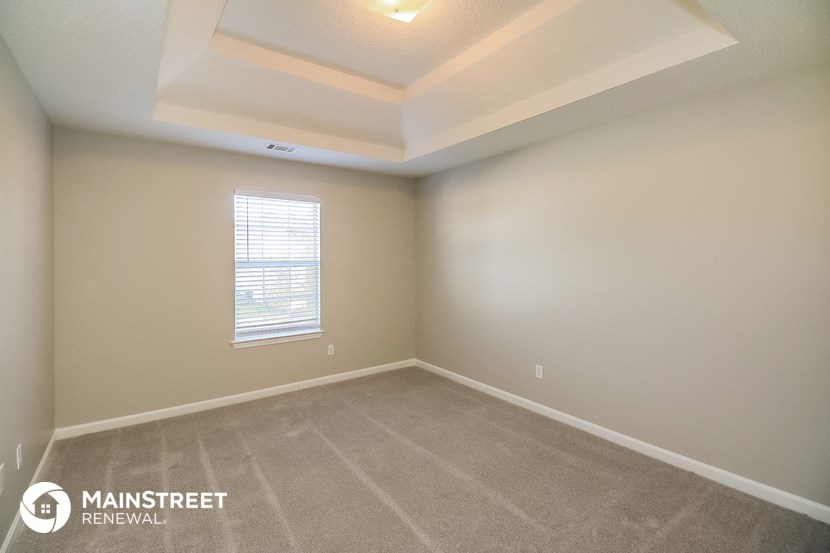 an empty room with carpet and a window